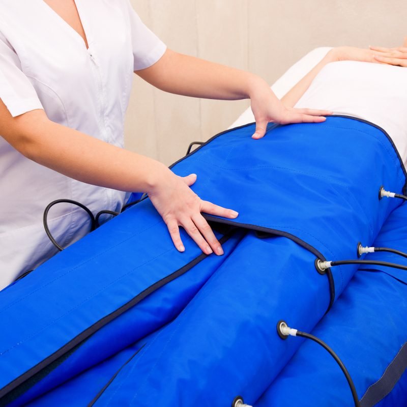 legs pressotherapy machine on woman in beauty center